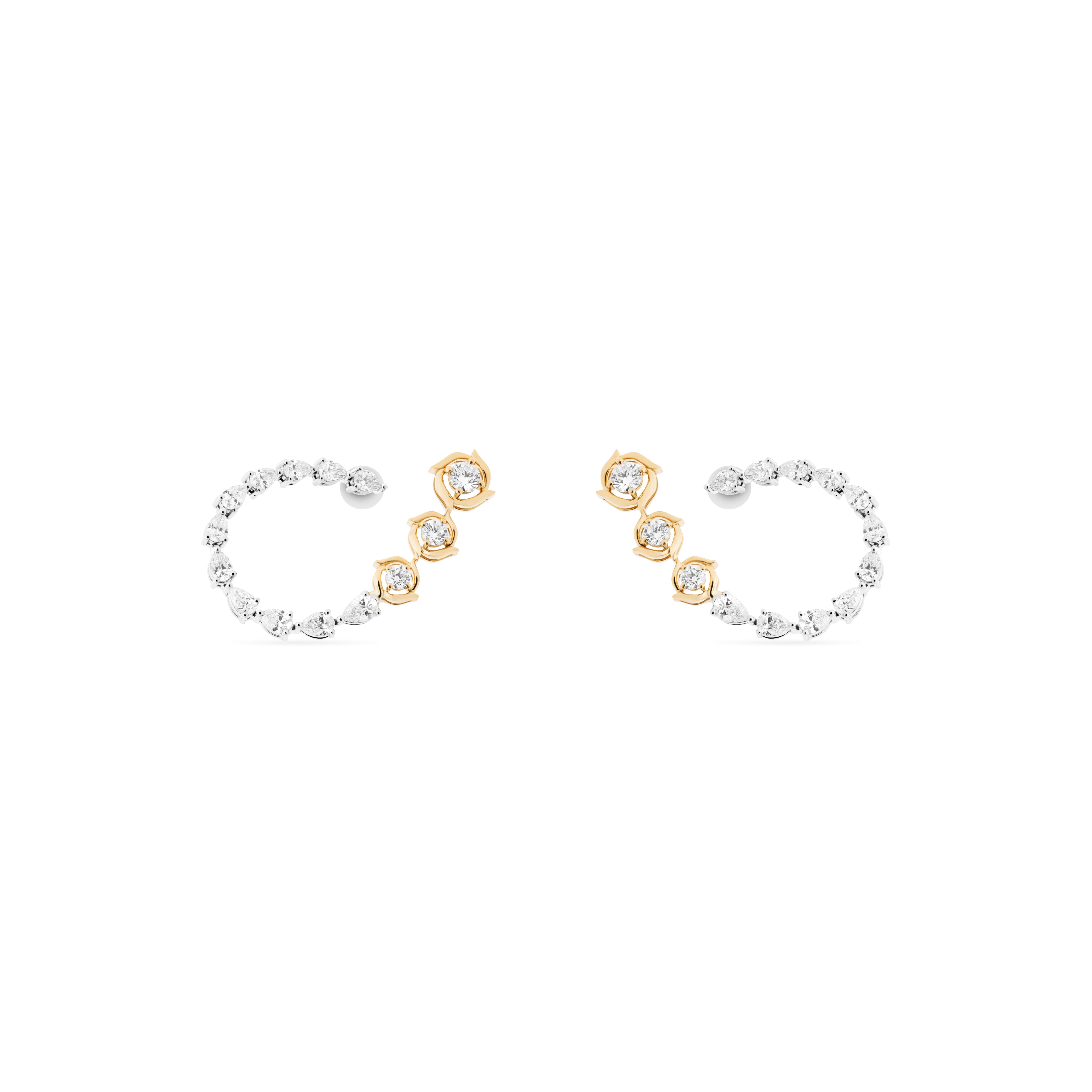 Pair of hoop earrings with gold and silver accents on a white background