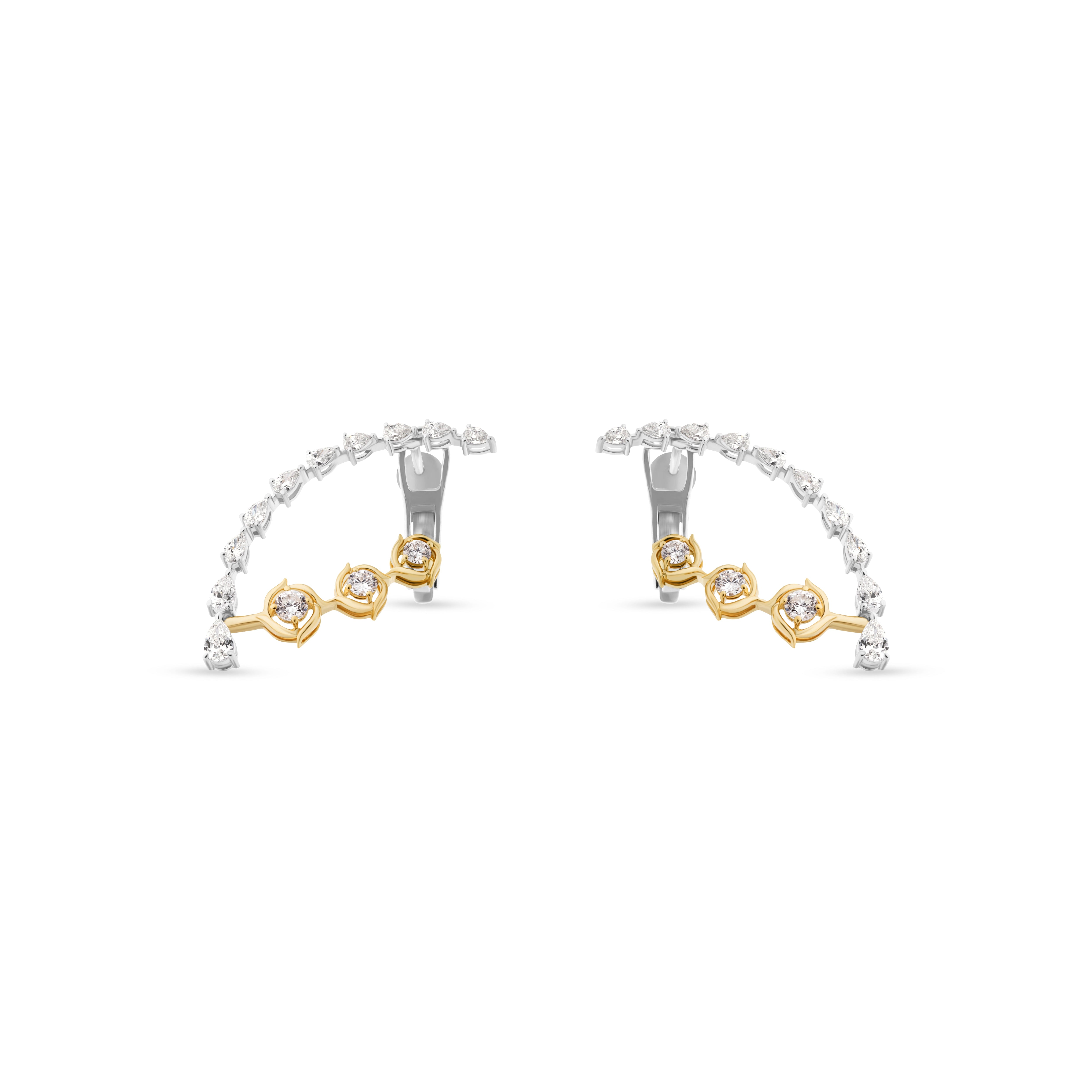 Pair of gold and silver hoop earrings on a white background