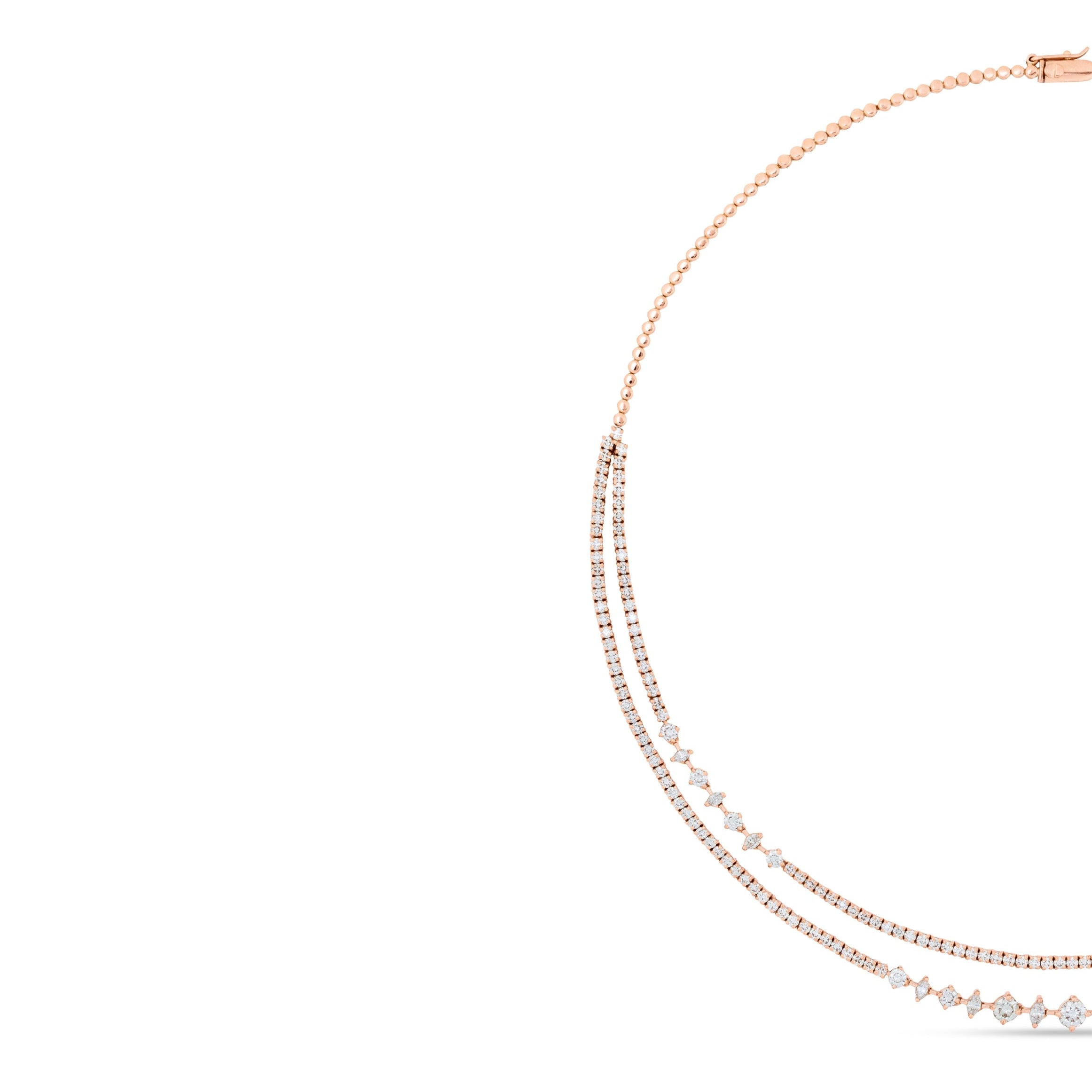 Rose gold necklace with small beads on a white background