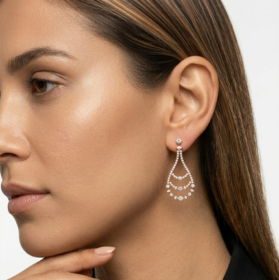 Close-up of a woman wearing a pair of earrings with a neutral background