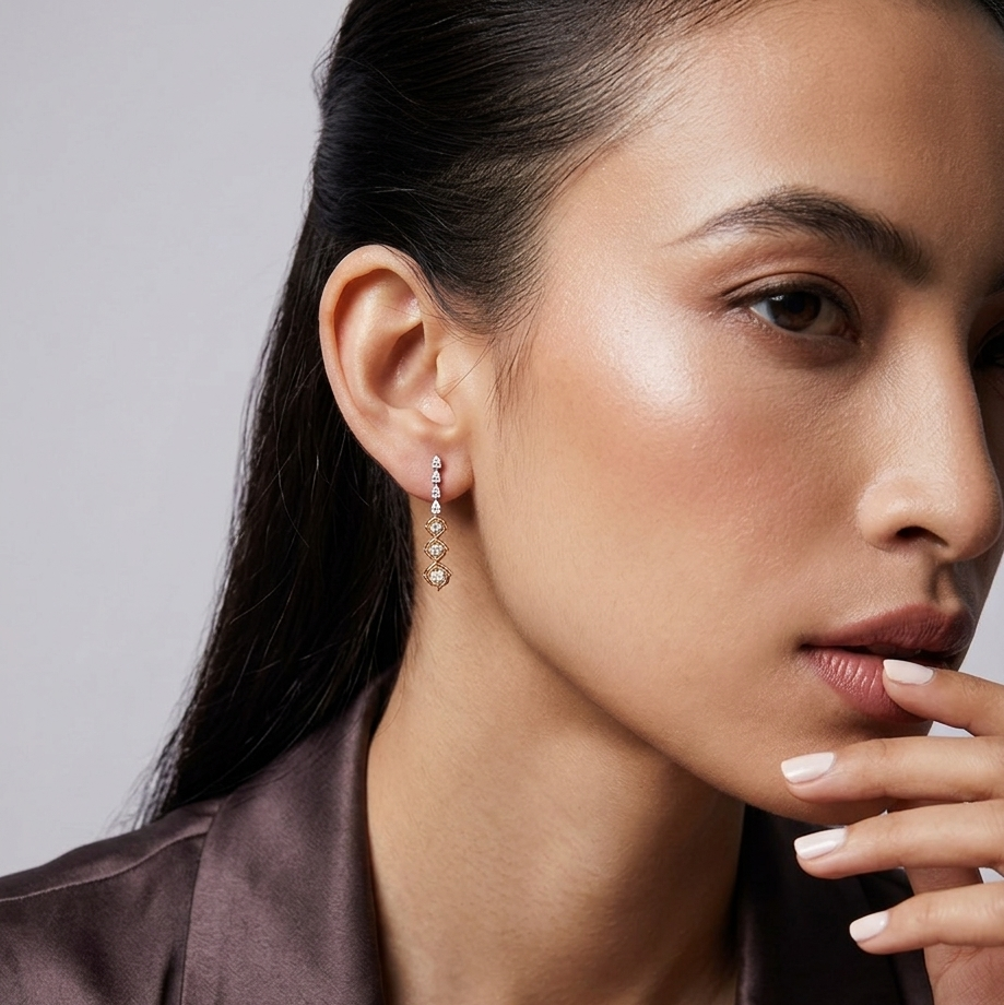 Close-up of a woman wearing an earring with a neutral background