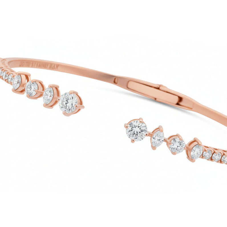 Rose gold bracelet with clear gemstones on a white background
