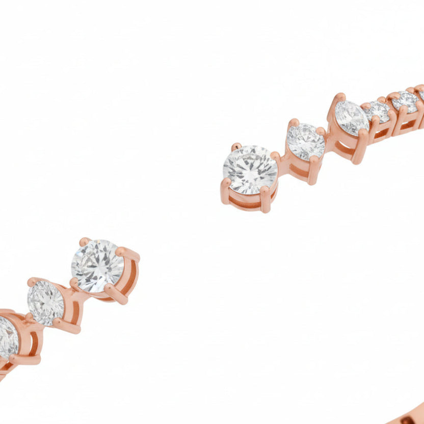 Rose gold bracelet with small diamonds on a white background