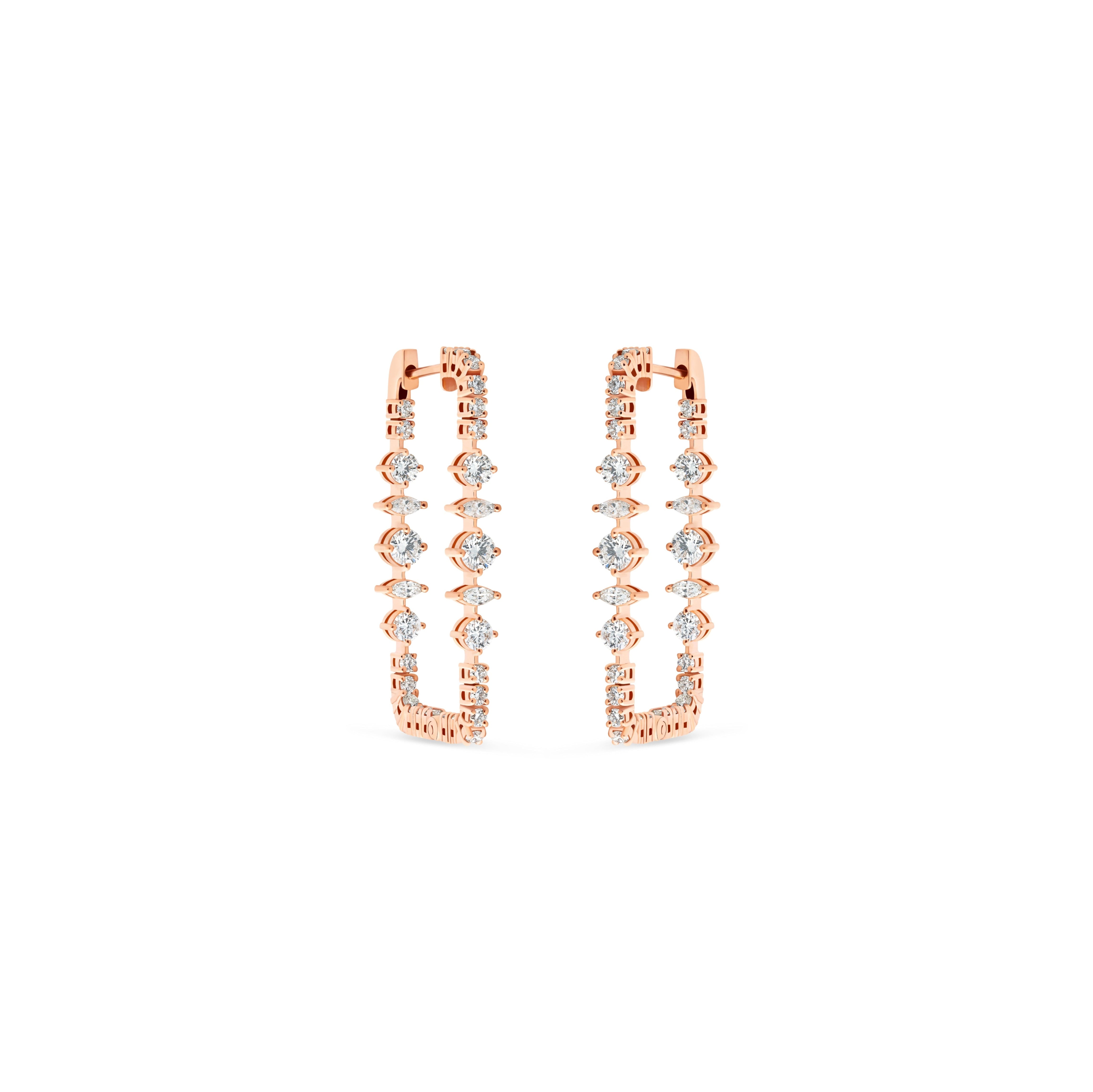 Rose gold hoop earrings with clear gemstones on a white background