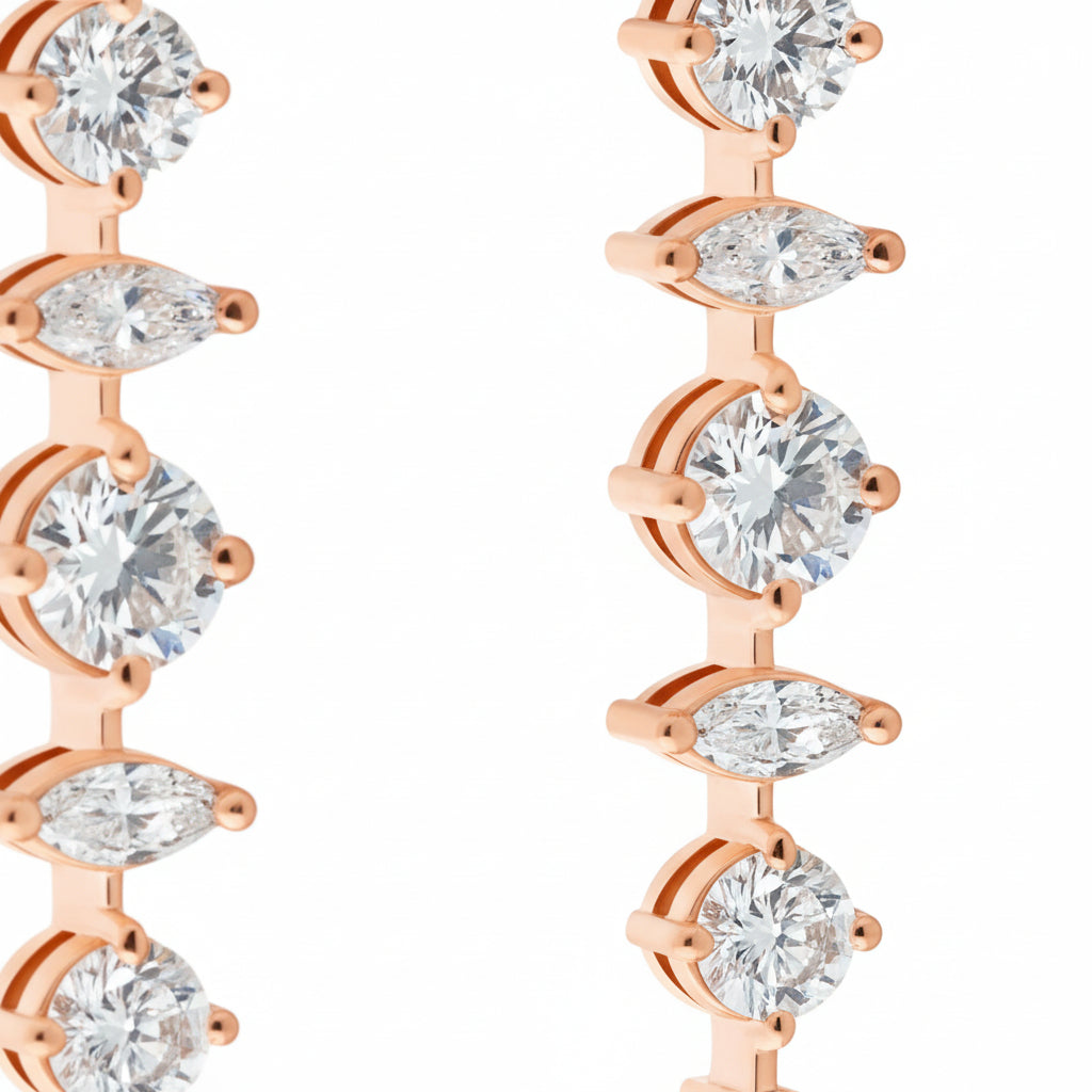 Rose gold hoop earrings with clear gemstones on a white background