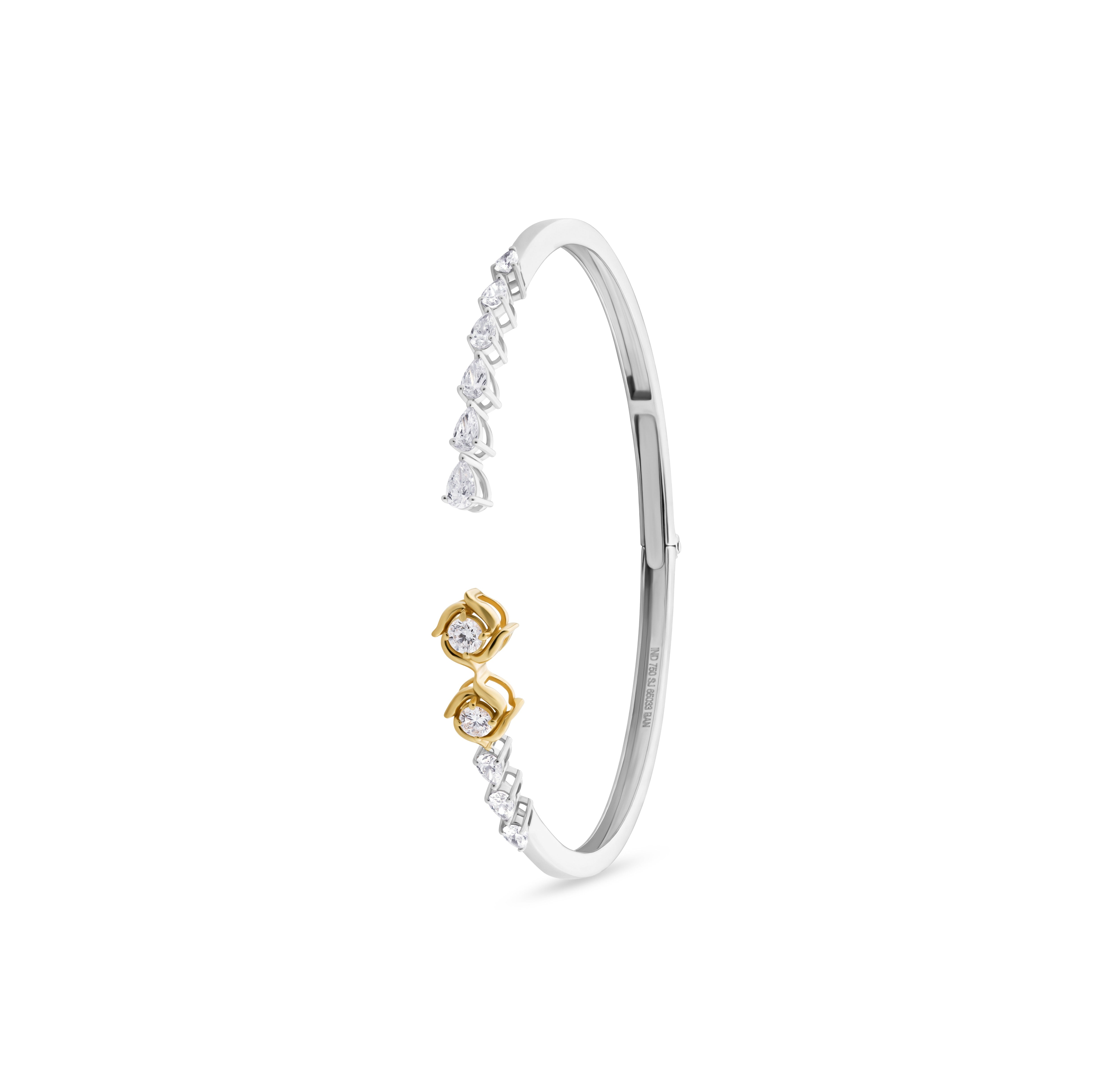 Silver bracelet with gold accents on a white background