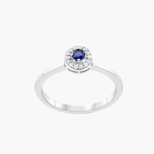 Silver ring with a blue gemstone and diamond accents on a gray background