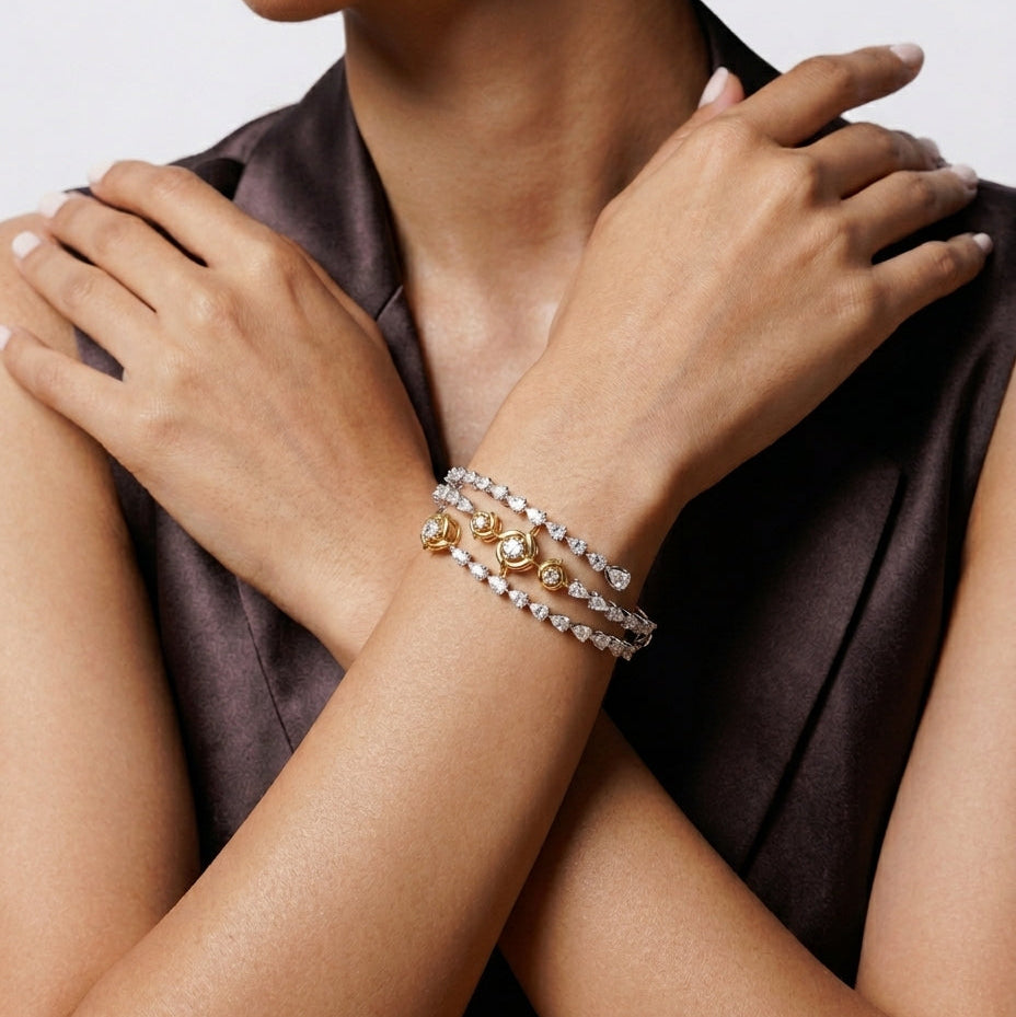 Close-up of a person wearing multiple bracelets on a plain background