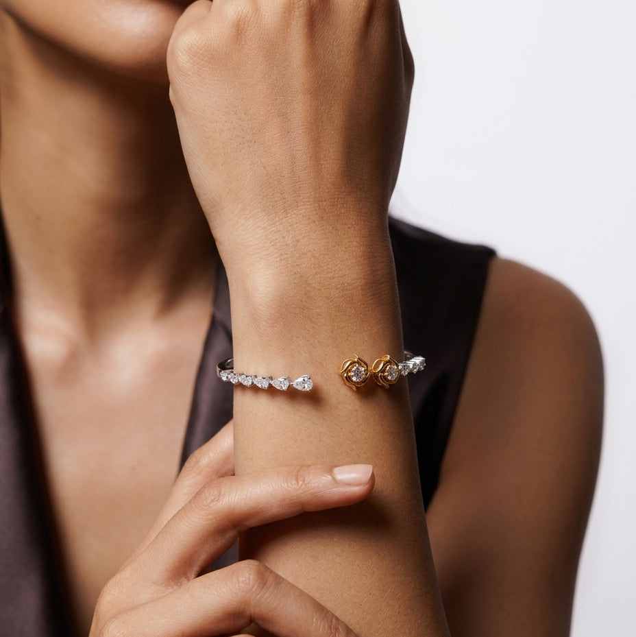 Close-up of a person's wrist wearing two bracelets on a neutral background